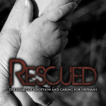 infant's hand holding the finger of adult with Recused: The Heart of Adoption and Caring for Orphans across photo