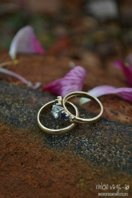 Woman's gold wedding band with diamond and sapphire engagement ring
