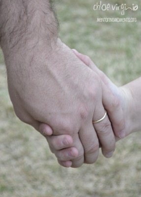 Father holding daughter's hand.