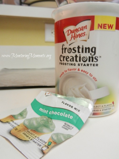 Container of Duncans Hines Frosting Creations and one mint flavoring pack.
